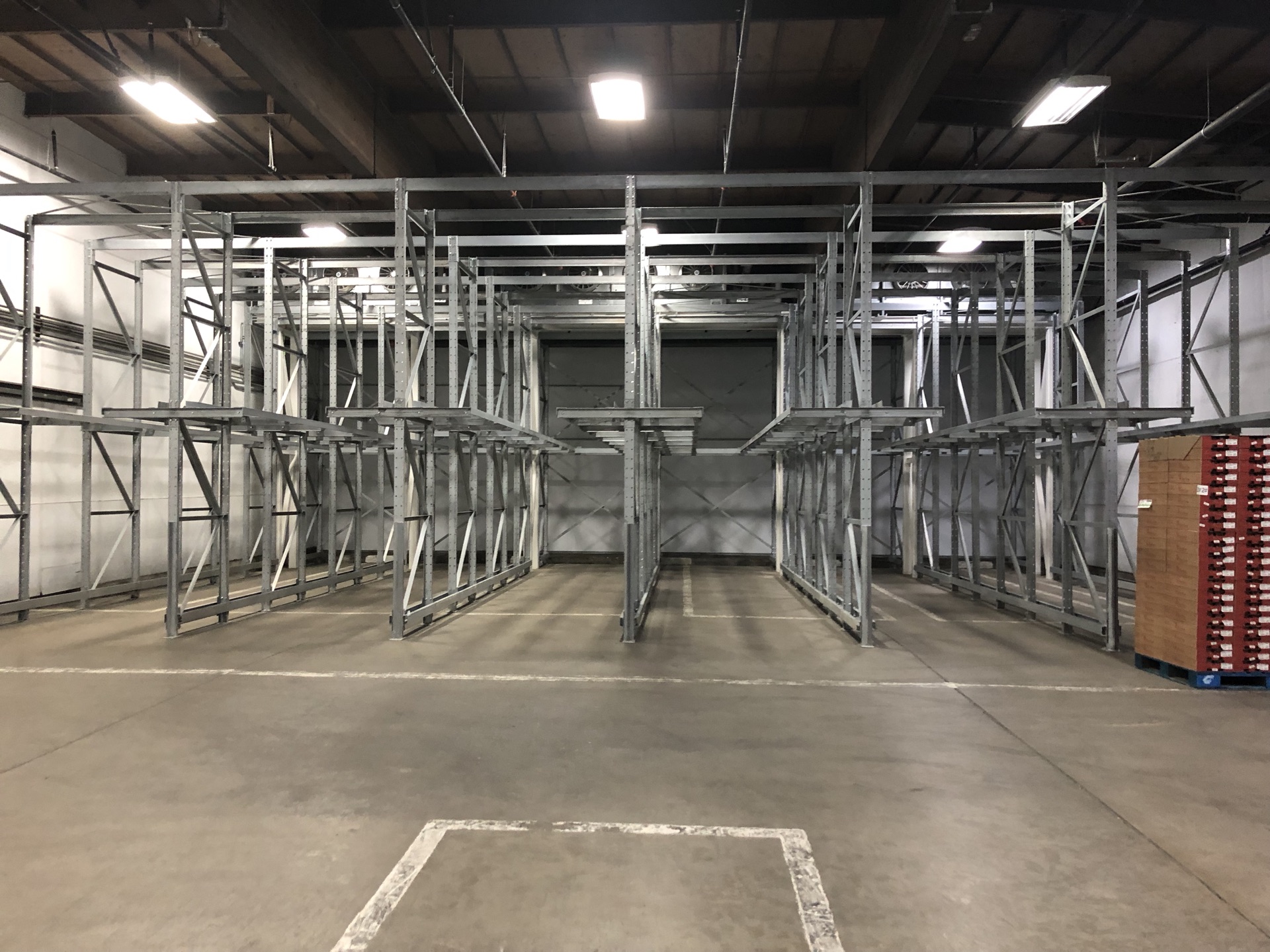 Twin pick drive-in rack frame with a symmetric center aisle