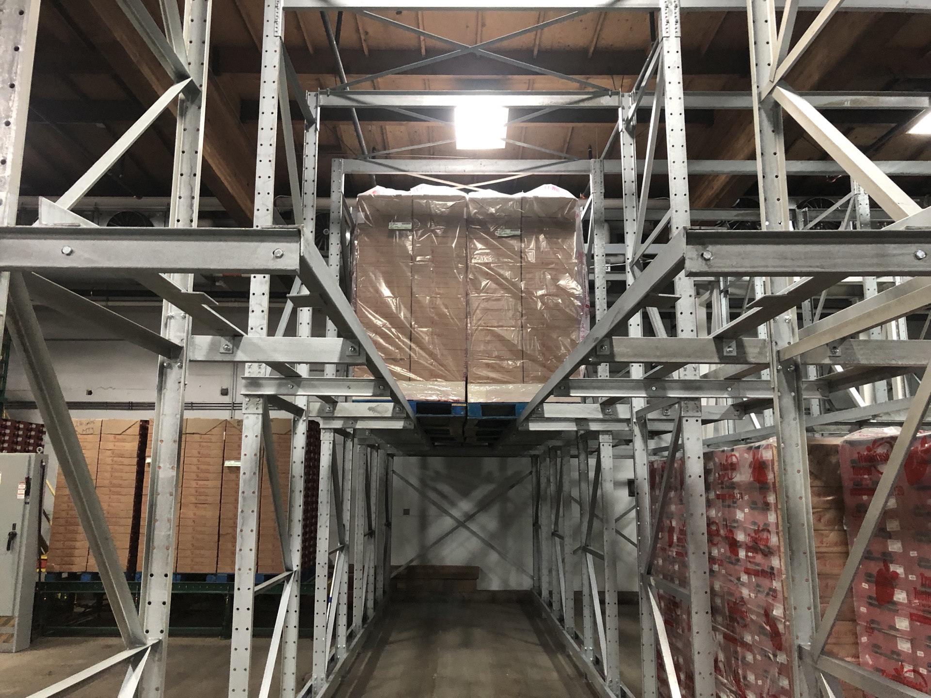 Close-up of a wrapped pallet staged in a dual-pallet drive-in lane