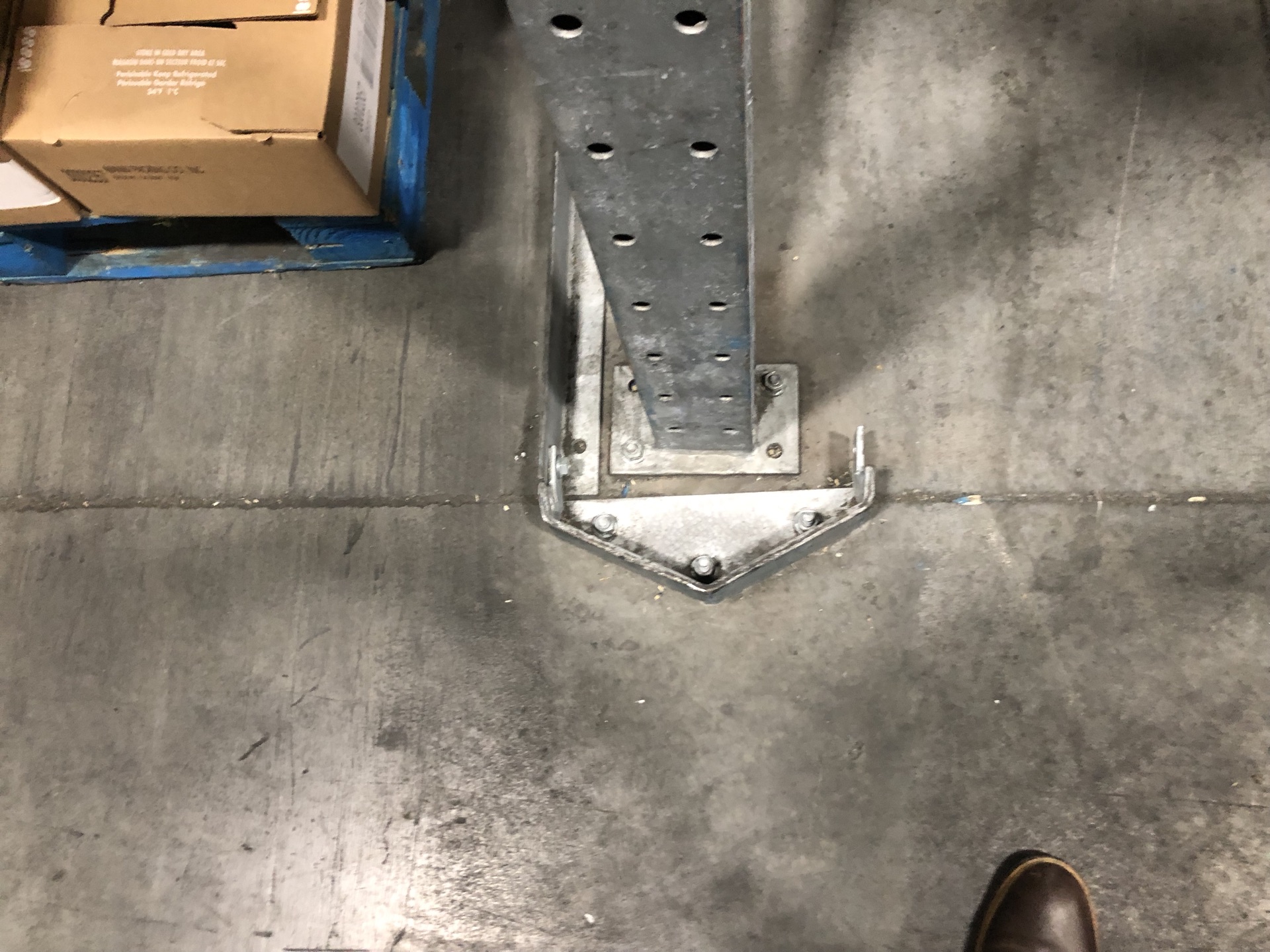 Close-up of a pallet rack entry guide at the lane opening