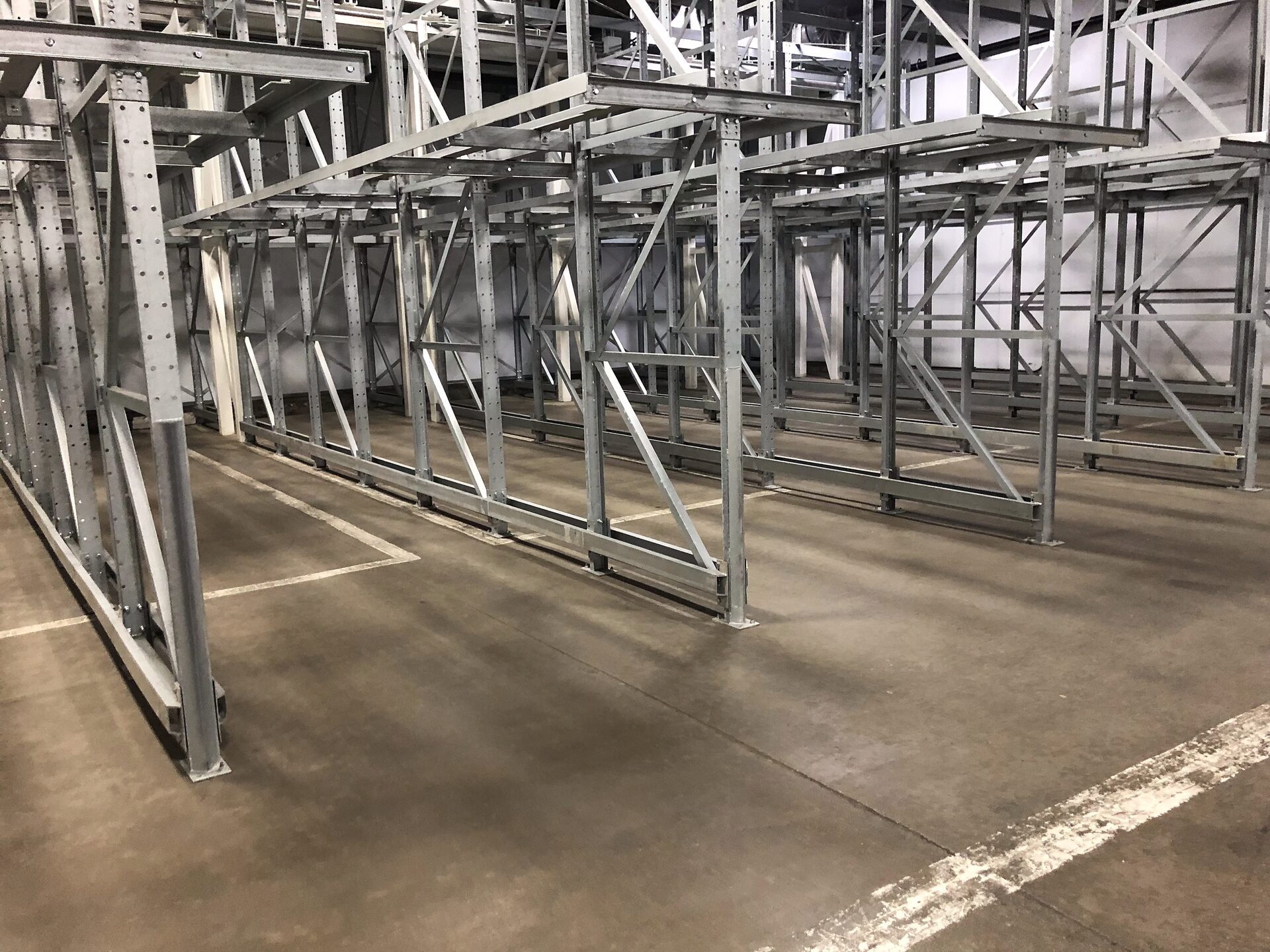 Rack aisle with guardrail-protected flow lanes